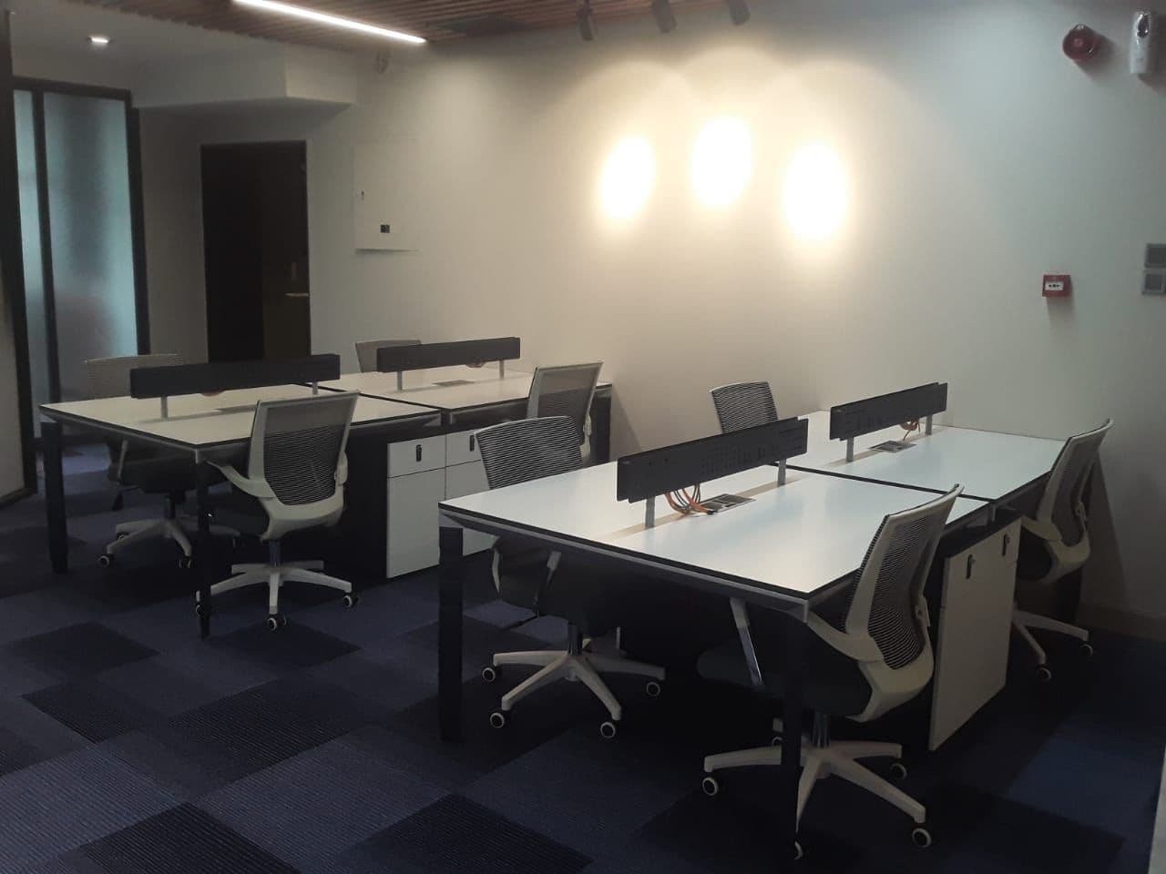 Compact Conference Room with Glass Table and Pendant Lights
